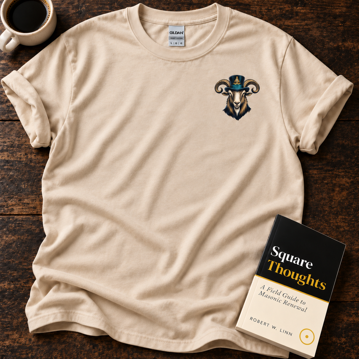 Sand Past Master Goat tee with a small goat in a top hat on the left chest, beside a Square Thoughts book